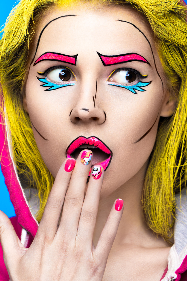 woman  with professional comic pop art make-up and design manicure.